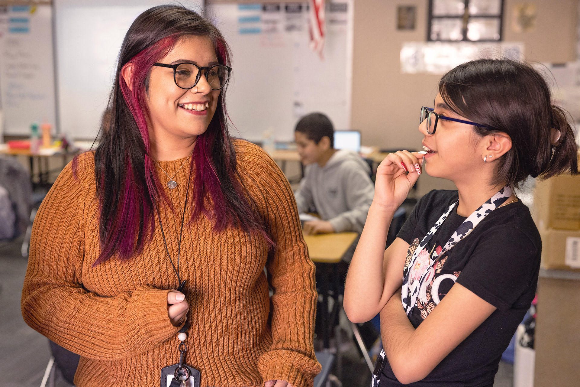 Two females students happily talking