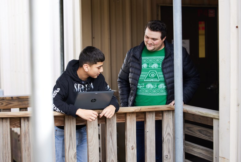 2 male students using a laptop