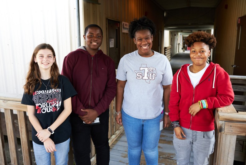 4 teenagers smiling