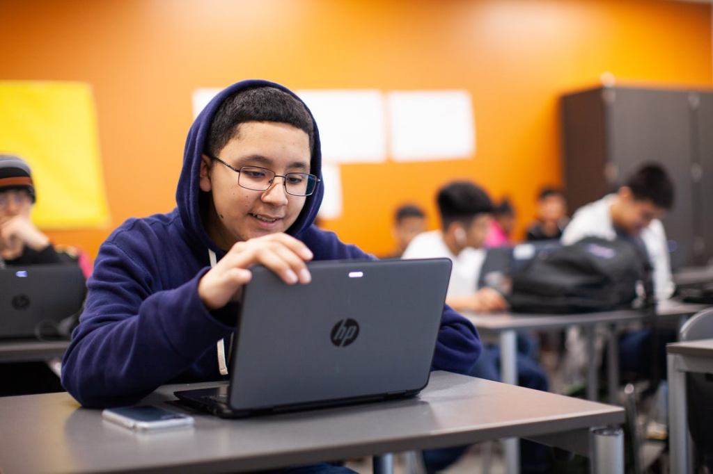 Male student using laptop