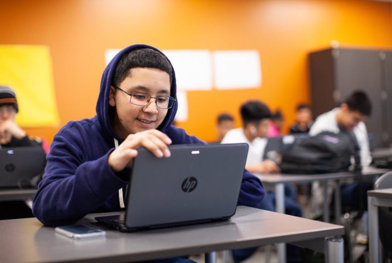 Male student using laptop